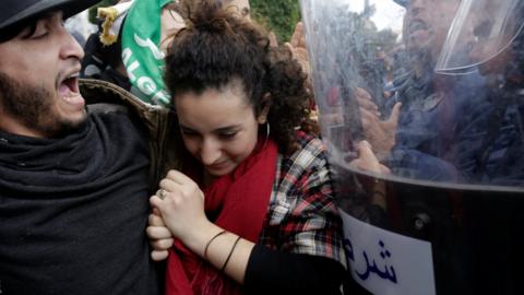 Police stand guard as students protest against the fifth term of Abdelaziz Bouteflika in Algiers