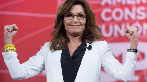 Sarah Palin flexes her muscles at a speech in January 2015.