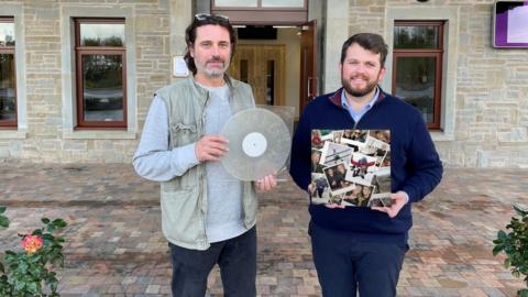 Jason Leach (left) and Matthew Brook (right) holding a vinyl and its sleeve