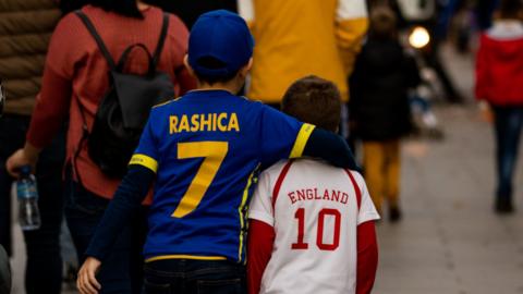 Children wearing Kosovo and England shirts