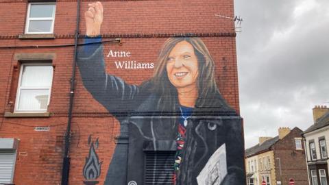 Mural of Anne Williams on exterior brick wall