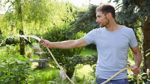 Man using a hosepipe