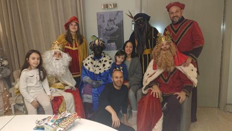 A photo of former Barcelona midfielder Andres Iniesta (centre) surrounded by his family and a group of people dressed in costumes to mark Three Kings Day, two of whom are in black makeup