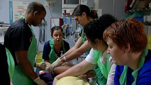 NHS workers treating a patient
