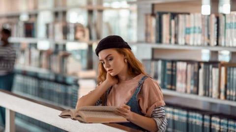 Woman reading in library