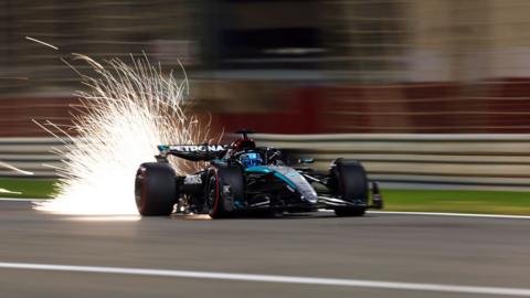 The Mercedes of George Russell throws up sparks as it runs low to the ground during the Bahrain Grand Prix