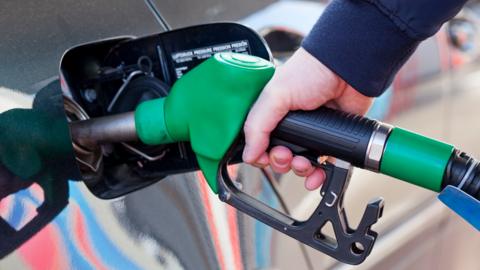 Stock image of a fuel pump being used to refuel a car
