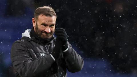 Bolton boss Ian Evatt applauds their supporters