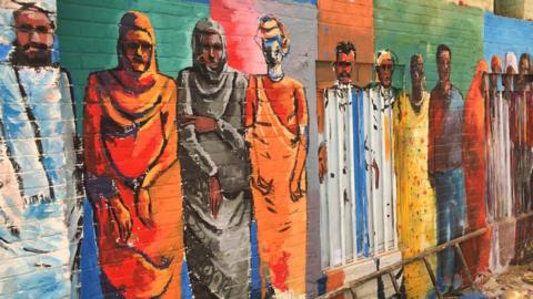 A mural of Sudanese people on a wall in Khartoum, Sudan