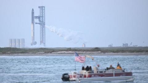 SpaceX with tourist boat in foreground