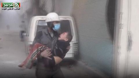 Member of White Helmets rescues child