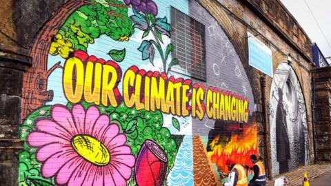 graffiti reading our climate is changing