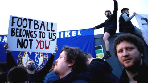 Fans protest the European Super League outside Stamford Bridge