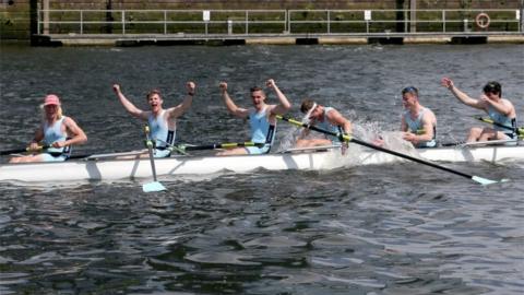 The mens eight from the University of Edinburgh celebrate beating their Glasgow rivals