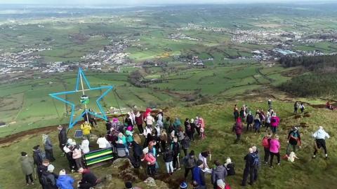 Hundreds of people hiked up a mountain in County Armagh last weekend to support a Newry woman who is living with motor neurone disease.