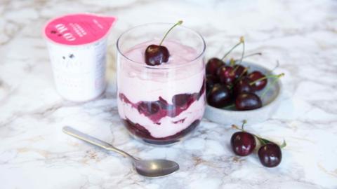 A picture of CoYo's coconut milk alternative yoghurt with some cherries