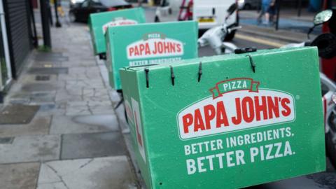 Papa John's delivery boxes strapped to motorcycles in London