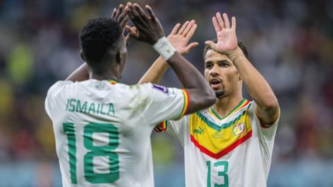 Ismaila Sarr and Ilian Ndiaye celebrate a Senegalese goal during the 2022 World Cup