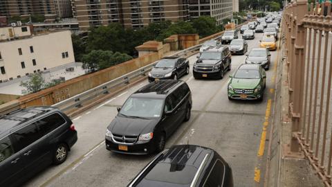 Cars drive through afternoon traffic on the Brooklyn Bridge on July 30, 2018 in New York City.