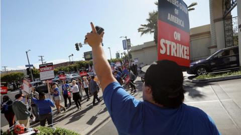 Workers and supporters of the Writers Guild of America protesting at a picket line outside Paramount Studios in Los Angeles on Tuesday