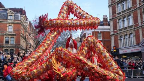 Performers take part in a parade involving costumes, lion dances and floats, to mark Lunar New Year, also known as the Spring Festival or Chinese New Year, in London.