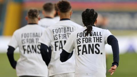 Leeds United players warm up before their match against Liverpool