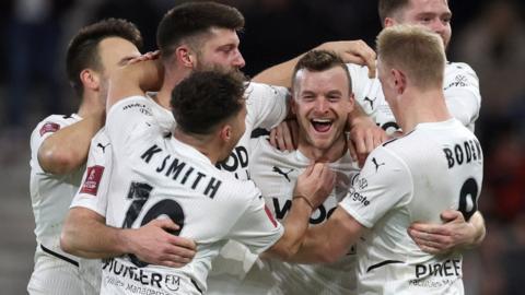Boreham Wood's players celebrate scoring against Bournemouth in the FA Cup