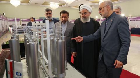 A handout file picture made available by Iran's presidency shows President Hassan Rouhani (C) and the head of the Atomic Energy Organisation of Iran, Ali Akbar Salehi (R), inspecting nuclear technology in Tehran, Iran (9 April 2019)