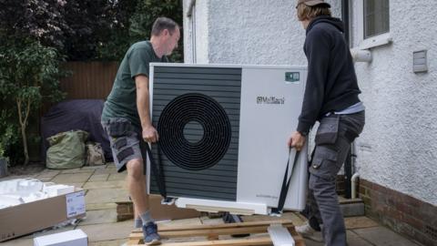 Air source heat pump installers from Solaris Energy installing a Vaillant Arotherm plus 7kw air source heat pump unit into a 1930s built house in Folkestone, United Kingdom on the 20th of September 2021.