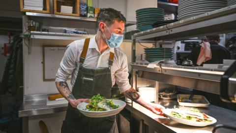 Waiter wearing face mask