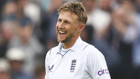 Joe Root smiles after hitting his century