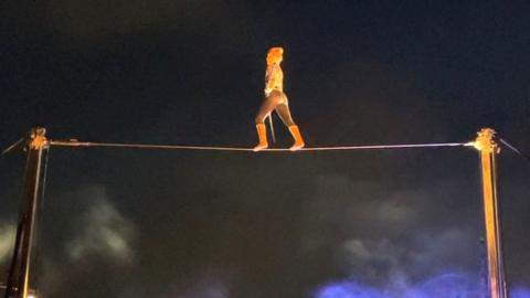 Trapeze act on wire