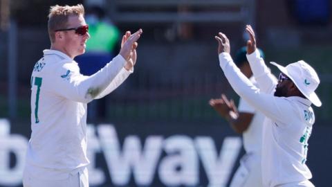 South Africa's Simon Harmer and Temba Bavuma celebrate