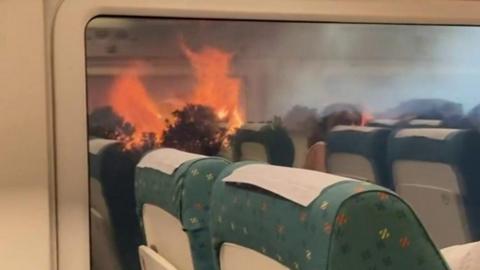View of wildfire through train window