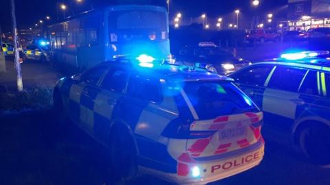 The stolen bus surrounded by police cars in Milton Keynes