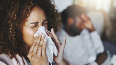 Woman sneezing