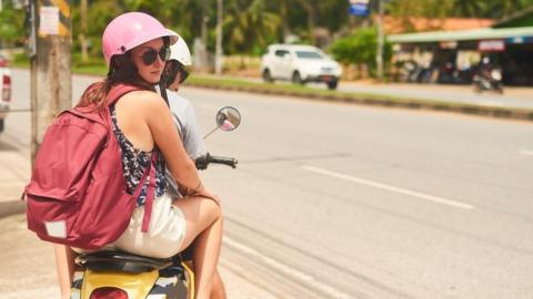 Woman and man on moped