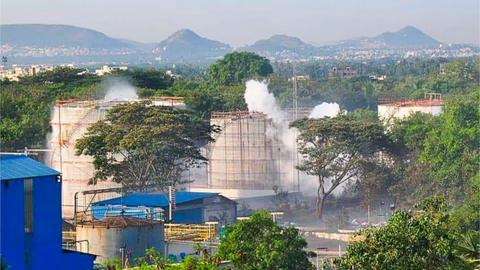 Smokes rise from an LG Polymers plant following a gas leak incident in Visakhapatnam on May 7, 2020. -