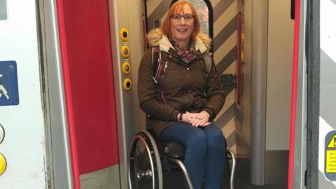 Wheelchair user Sarah Ward on a train
