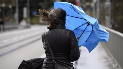 A Swiss woman battles against the wind