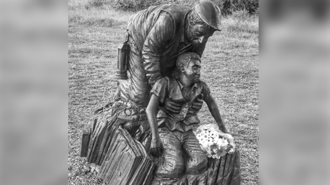 Sculpture of a miner cradling a boy