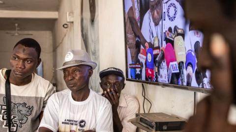 Supporters of President of Gambia Adama Barrow listen to results in Banjul on November 5, 2021