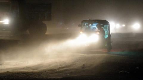 People in a rickshaw during a dust storm in Mathura, Uttar Pradesh state, India. Photo: 3 May 2018