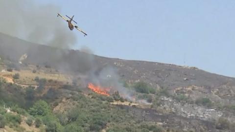 Plane flies over wildfire