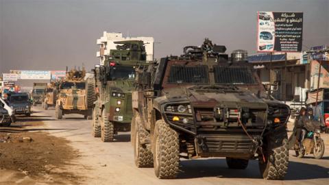 Turkish military convoy passes through the Syrian town of Dana on 2 February 2020