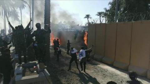 Protesters breaking into the US compound