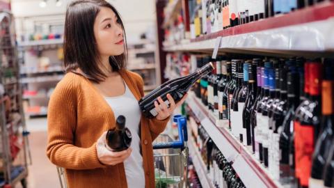 Woman buying alcohol