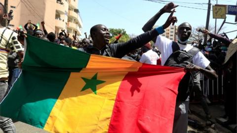 Supporters of opposition leader Ousmane Sonko, who was indicted and released on bail under judicial supervision, attend a demonstration in front of the court in Dakar, Senegal March 8, 2021.