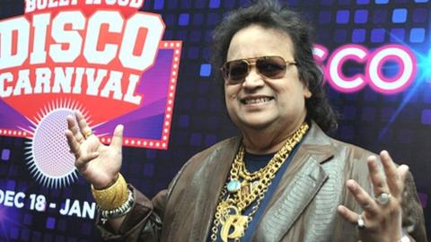 Indian Bollywood music composer and singer Bappi Lahiri poses during the Christmas and New Year's Bollywood Disco Carnival in Mumbai on December 18, 2015.
