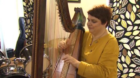 Elin Angharad playing the triple harp